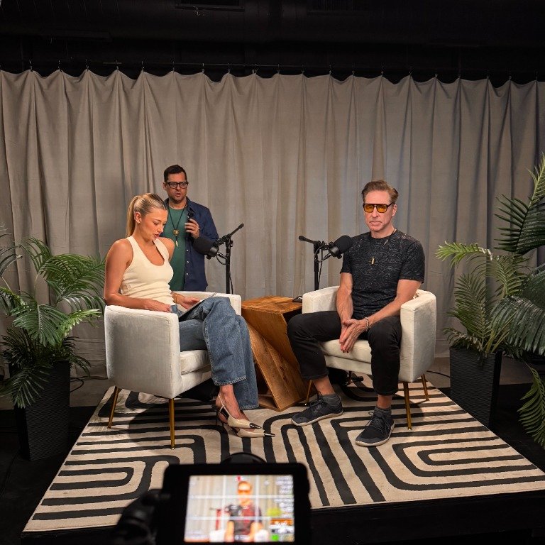 Behind the scenes view of podcast recording session showing technical crew