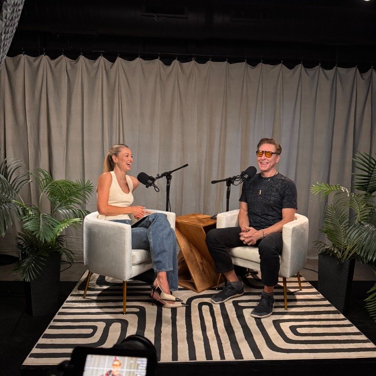 Host and guest laughing during recording session at Purple Bee Studios